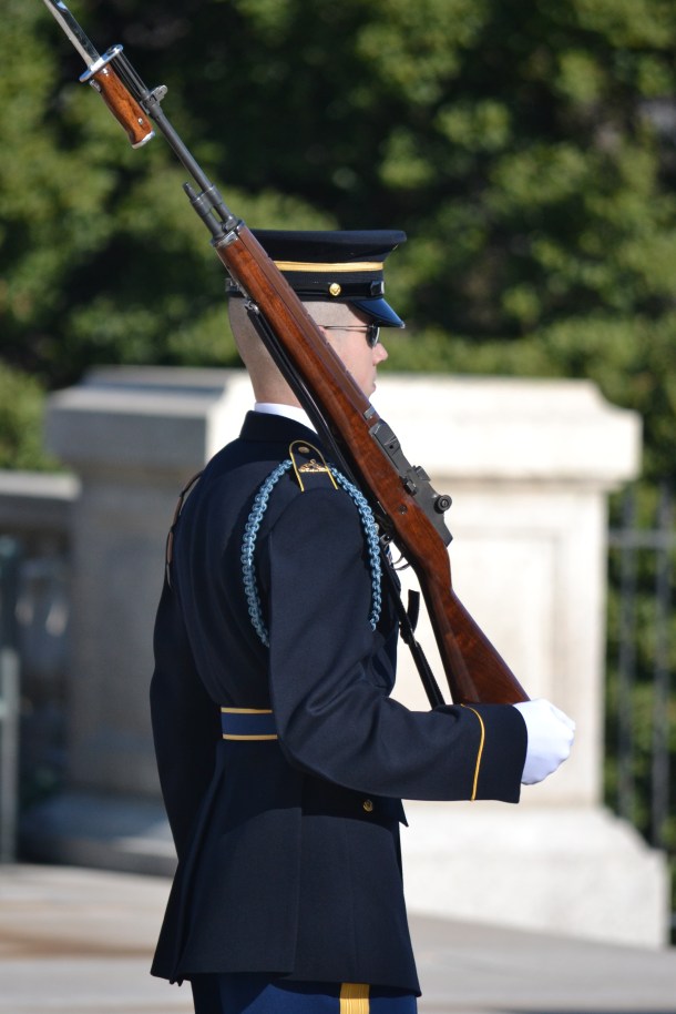 The relieved guard stands at attention